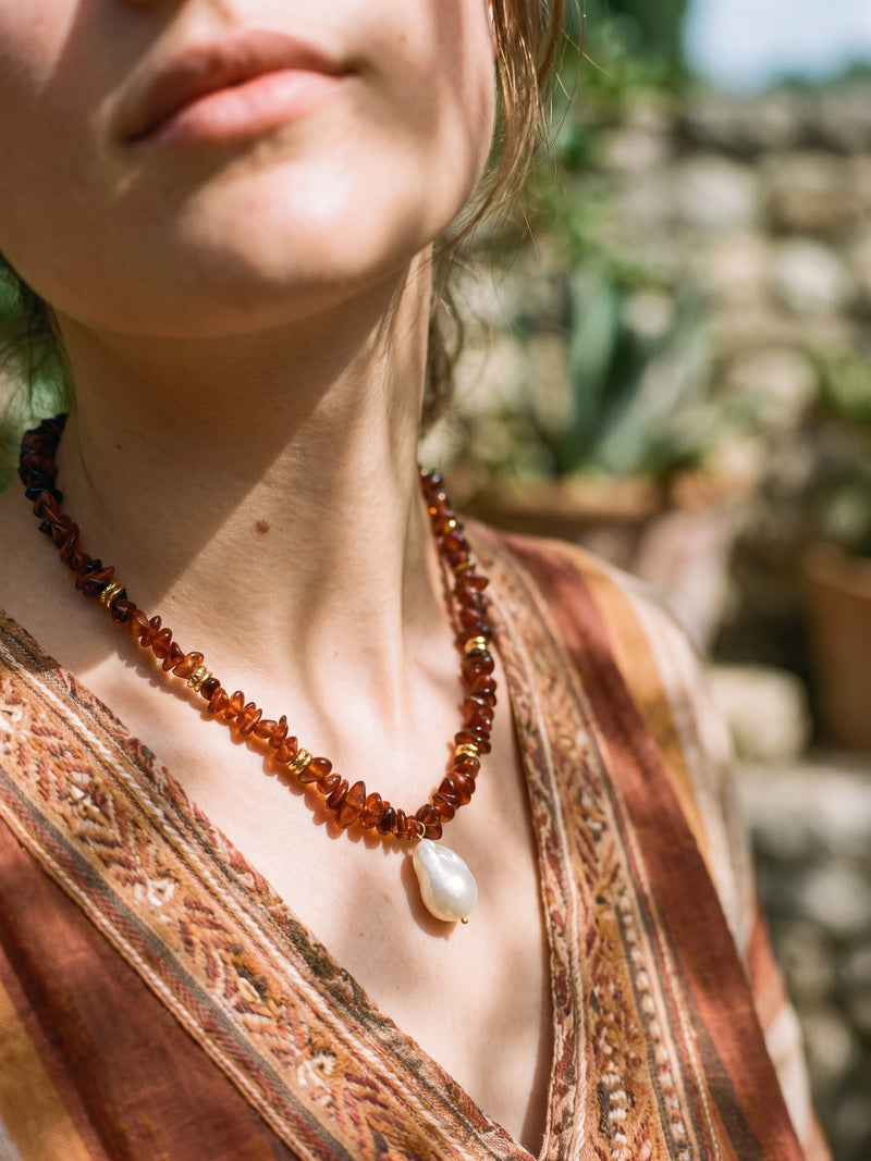 Vulkanblüte necklace with white pearl pendant, side close-up shot on model