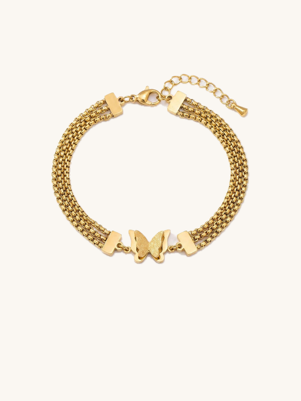 Papillon Gold Bracelet – Three-strand box chain bracelet with a golden butterfly, matte shimmering wings, white background