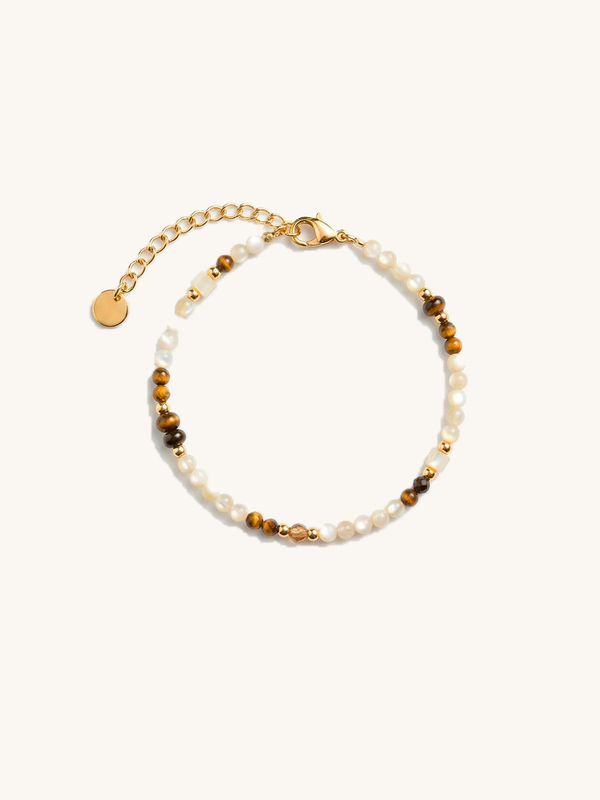 Sahel Bracelet – Handcrafted bracelet with shell beads, tiger's eye, and golden accents, white background