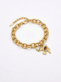 Armband Liberte Gold – Kraeftige Gliederkette mit goldenem Vogel-Anhaenger und Tigerauge-Cabochon, weisser Hintergrund