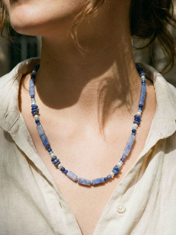 Kette Blauweiss Wuerfel – Detailaufnahme am Hals getragen, Nahaufnahme Anhaenger und Perlen