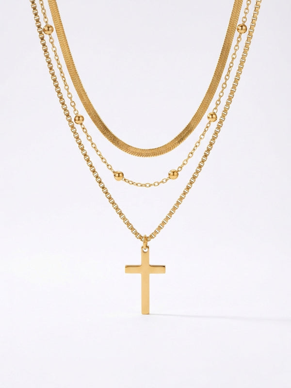 Devotion Kreuz Kette Produktfoto – vergoldete mehrreihige Kette mit Kreuzanhaenger auf weissem Hintergrund