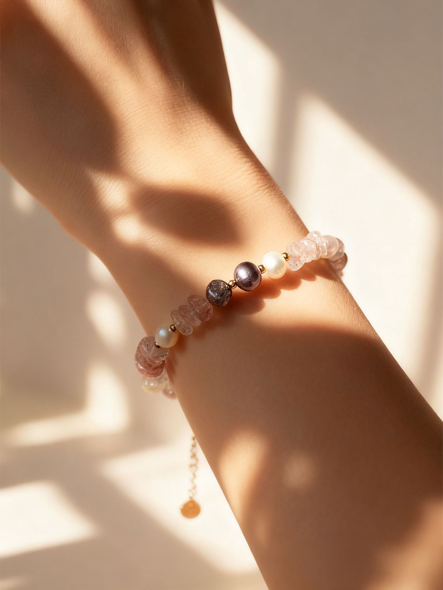 Trageansicht: Mondlicht Armband an zierlicher Hand – femininer Naturschmuck mit Pastellsteinen und Perle