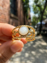 Ocean Twist Ring Nahaufnahme Perlmutt Stein in der Hand natuerliches Sonnenlicht Nemomatheo