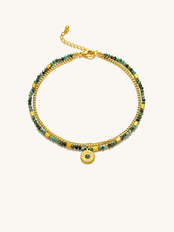 African turquoise bracelet completely on a white background - double-strand boho design with golden sunflower charm